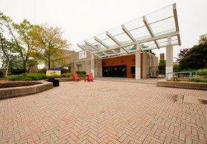 View of the front entrance, sign and glass awning. 