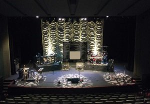 View of the auditorium stage from the back-centre seating section.